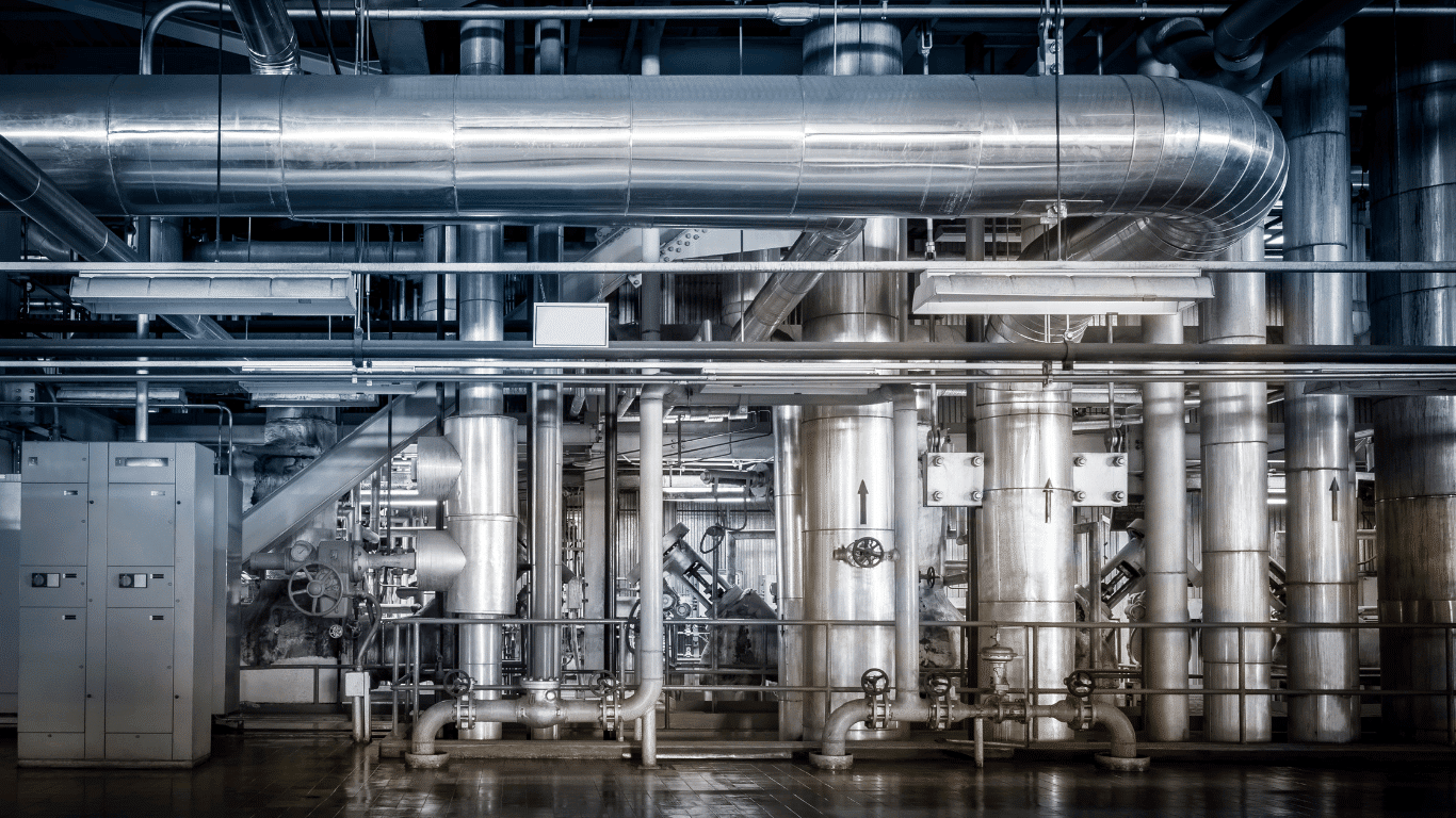 Industrial water softener systems in a large facility, showing industrial ion exchange softener equipment used for industrial hardness removal, boiler feedwater softening, and cooling tower softening. Image represents an industrial water softener manufacturer’s softener skid systems, water softener service and parts, resin replacement operations, and industrial water treatment equipment.