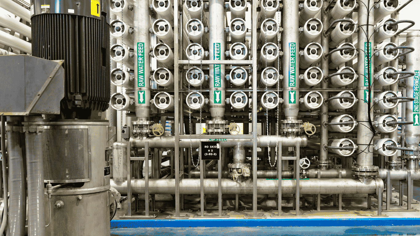Industrial reverse osmosis system showing stainless steel ro vessels, a semipermeable membrane and reverse osmosis membrane used in the filtration process where water flows through an ro filter with a carbon block filter, granular activated carbon, cartridge filtration, and multi media filter to remove contaminants, trap particles, remove organic material, and support contaminant reduction by removing dissolved solids and dissolved salts from tap water, as water pressure pushes water molecules through the reverse osmosis ro process to produce purified water and fresh water for drinking water, bottled water companies, and water tank storage, demonstrating the natural flow of the feed stream, waste water discharge, beneficial minerals balance, improved water tastes, health benefits, and efficient water flows that can deliver results in a few minutes while supporting bottled water companies and modern drinking water treatment.