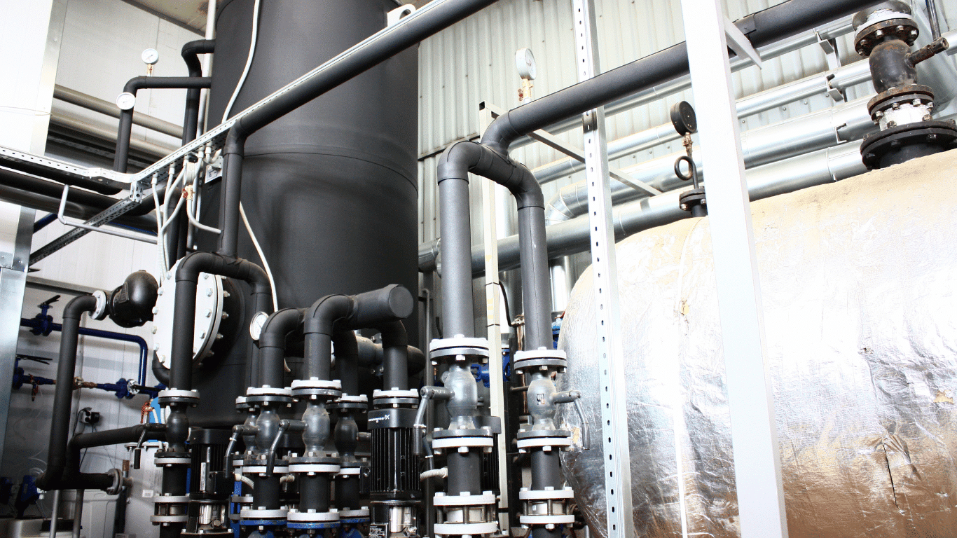 Industrial glycol chiller equipment and piping installed in a closed loop mechanical room supporting glycol systems used for industrial cooling in hvac systems and food processing facilities, where technicians manage a glycol solution made with propylene glycol or ethylene glycol to provide freeze protection and temperature control in low temperature environments. This chiller system and refrigeration system circulate coolant through a closed loop configuration that includes pumps, insulated tanks, valves, and other system components designed to maintain high cooling capacity, strong system efficiency, and improved energy efficiency while delivering reliable temperature control for industrial processes, food processing equipment, and large hvac systems operating in cold weather or fluctuating ambient temperature conditions.  Technicians monitor glycol concentration and practice proper mixing glycol with water to create an effective glycol solution using propylene glycol or ethylene glycol, two organic compounds in the alcohol family commonly used for automotive antifreeze and refrigeration fluids because they provide a lower freezing point and excellent antifreeze properties for freeze protection in closed loop glycol systems. These fluids help the glycol chiller and refrigeration unit maintain stable temperatures by improving heat absorption, limiting heat gain, and supporting efficient cooling in demanding industrial cooling environments. Proper glycol concentration also supports thermal performance, protects against fluid degradation, and helps maintain temperature stability across closed loop piping networks.  In many hvac systems, the glycol chiller works with pumps, insulated tanks, and a glycol power pack to circulate coolant through a closed loop configuration designed to support industrial cooling, improve energy efficiency, and optimize system efficiency for commercial systems and manufacturing facilities. Facility engineers regularly inspect system components, evaluate cooling capacity, and verify saturated suction temperature values within the refrigeration system to ensure the chiller system and refrigeration unit perform reliably in low temperature environments. These maintenance practices also help prevent bacterial growth, manage fluid degradation, and improve long-term corrosion protection and corrosion control within the piping network.  Specialized glycol systems are also used in beverage applications such as draft beer dispensing and beer lines, where a glycol draft system powered by a glycol power pack circulates a chilled glycol solution through a closed loop to maintain temperature across long tap runs and protect potable water supply separation in food processing and hospitality environments. In these applications, the glycol chiller supports temperature control, prevents bacterial growth, and ensures sanitary operation for food processing equipment and beverage service while maintaining high system efficiency and reliable cooling capacity.  Understanding why is glycol widely used in glycol systems comes down to its strong antifreeze properties, ability to lower the freezing point of a glycol solution, and compatibility with corrosion inhibitors that improve corrosion protection in closed loop piping. When properly maintained with the correct glycol concentration, mixing glycol procedures, and quality corrosion inhibitors, these closed loop glycol systems provide dependable industrial cooling, stable temperature control, strong energy efficiency, and optimized thermal performance across a wide range of industrial processes, hvac systems, and food processing operations.