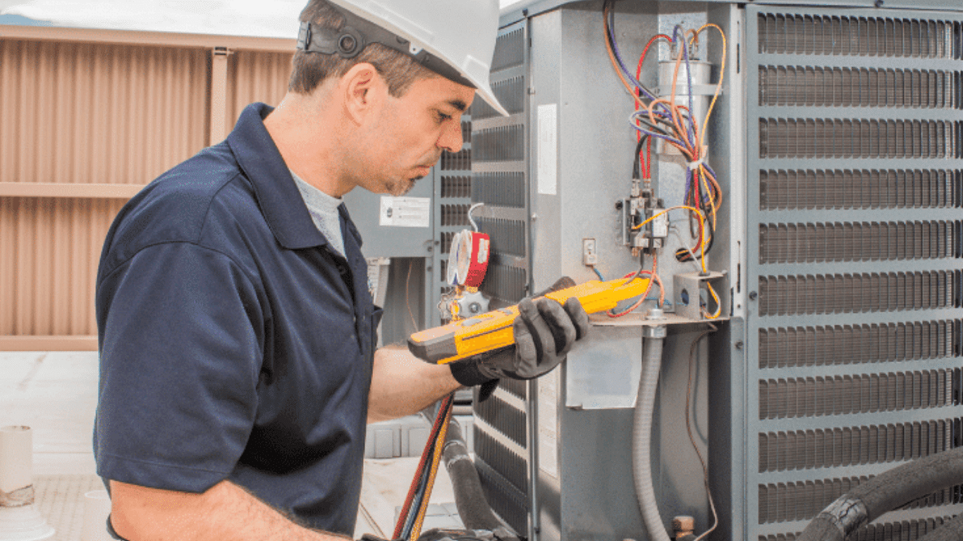 HVAC professional inspecting an air conditioning unit with tools, highlighting hvac condensation issues in an ac system where condensation forms due to excess moisture, dirty air filter, or inadequate airflow, affecting the evaporator coil, drain pan, and condensate drain line as water droplets form and condensation drips into the system's drain pan, requiring proper airflow, clean air filter maintenance, and a functional condensate pump to prevent clogged drain line, excess condensation, and potential leak in the hvac unit.