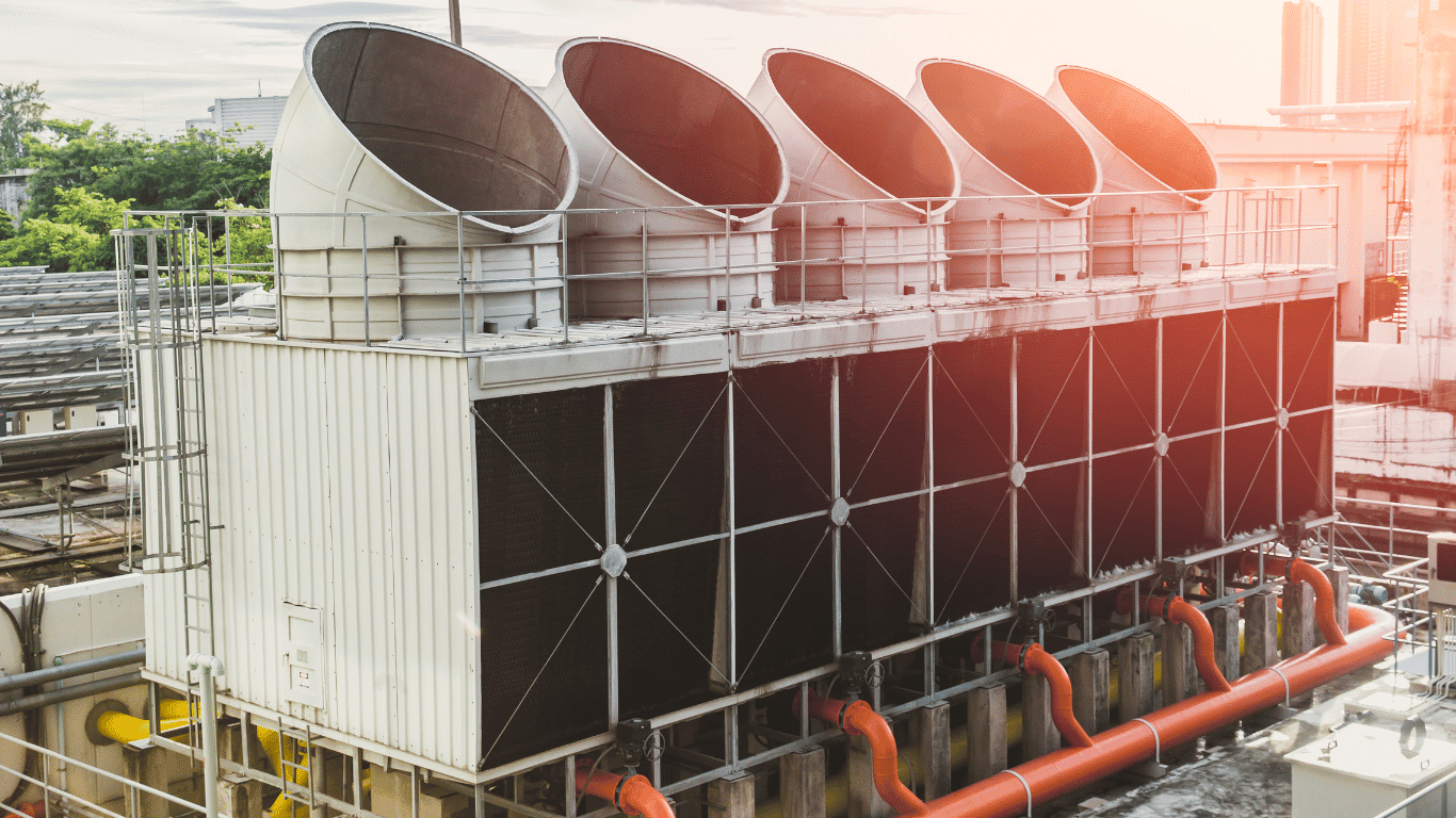 Cooling tower system with fill media including splash fill and film fill, showing air flow and water flow over thin film surfaces to increase the surface area for heat transfer during the cooling process in air conditioning systems and industrial cooling applications.