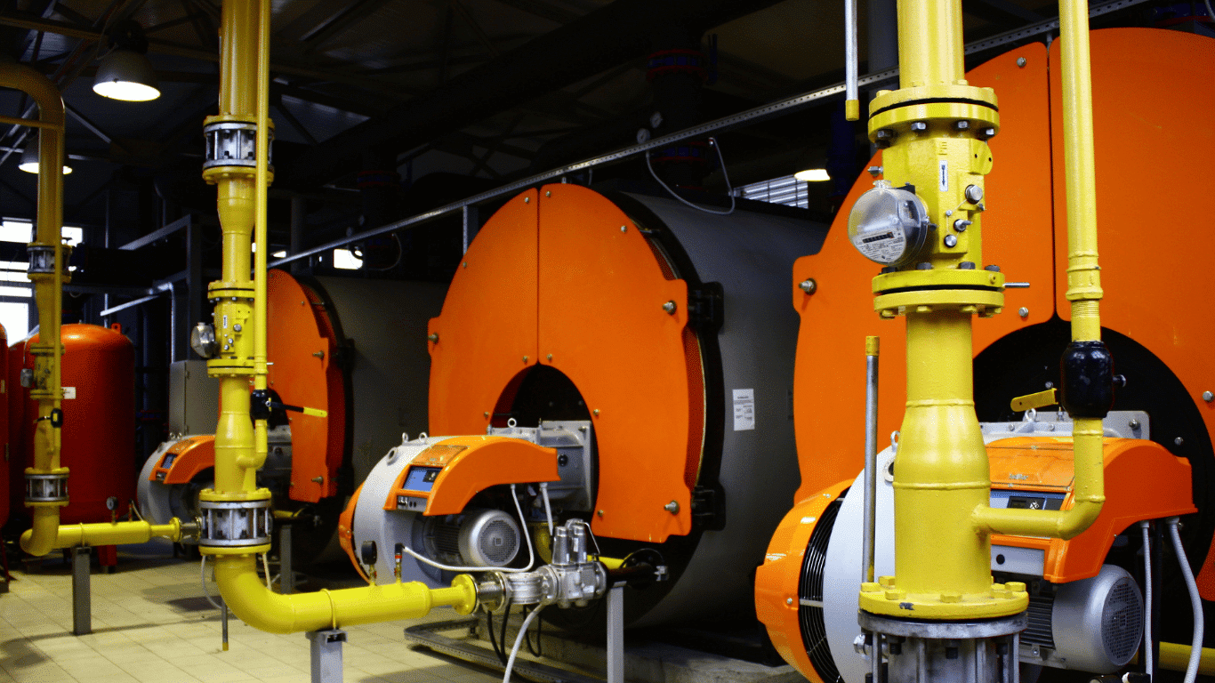 Industrial boiler system with water tube boilers and fire tube boilers producing steam and hot water through fuel combustion, showing tubes, fire tubes, outer shell, and heat exchanger components used in industrial heating applications, power plants, and steam generation systems.