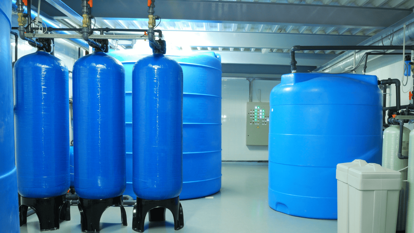 Industrial water softener system showing tank units used in water softener regeneration cycle and softener regeneration, where resin beads inside the tank capture calcium and magnesium ions during the softening process, helping reduce water hardness and hardness minerals in hard water to produce softened water for household water usage and improved water quality.