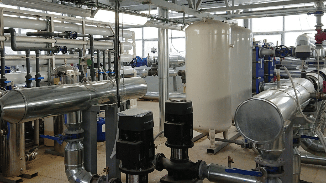 Industrial closed loop water treatment setup showing closed loop systems and a closed loop water system circulating loop water through pipes, pumps, and a heat exchanger to maintain water quality and system performance. This closed loop water treatment configuration highlights closed loops and closed systems used in cooling systems and chilled water systems, including closed recirculating systems designed for efficient heat transfer and improved heat transfer efficiency. Proper treatment and proper chemical treatment with chemical treatments and loop water treatment help prevent corrosion, reduce dissolved oxygen, control microbial growth and biological fouling, and limit scale formation on pipe surfaces and metallic surfaces. The system supports better control, energy efficient operation, and energy efficiency while reducing maintenance costs, energy consumption, and increased operational costs, helping industrial facilities, power plants, and industrial applications maintain equipment life and avoid costly repairs.