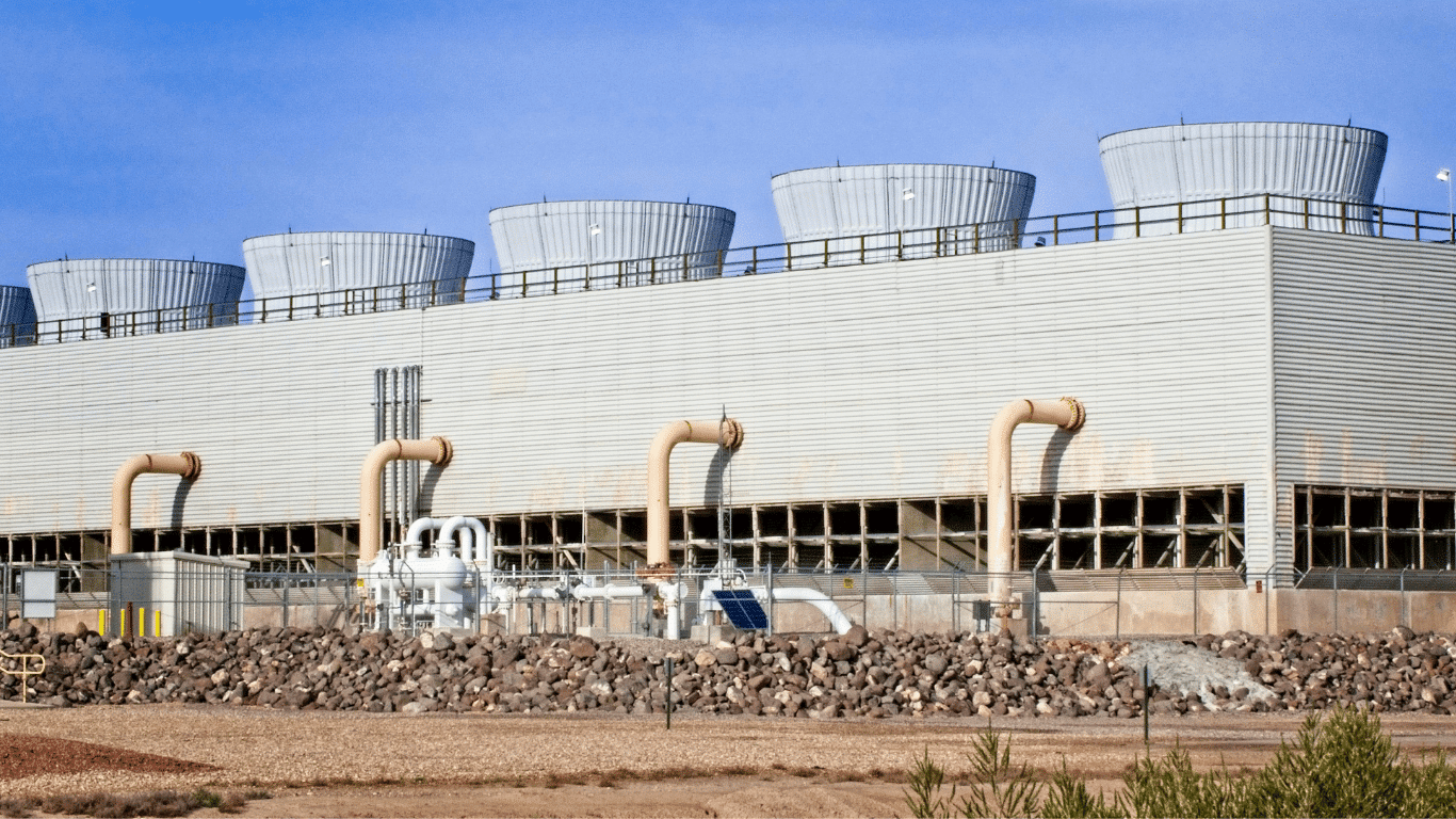 Industrial cooling tower system with visible cooling tower design and tower system structure, showing cooling tower water circulating through pipes as ambient air moves across the tower fill. In this cooling system, water evaporates during evaporation, leaving higher concentration of total dissolved solids, suspended solids, calcium, magnesium, silica, and calcium carbonate that can form scale and lead to scale formation on heat exchange surfaces. The blowdown process removes blowdown water from circulating water to control concentration, conductivity, and system’s water quality, preventing scale buildup, corrosion, and issues that accelerate corrosion. Proper control using a conductivity controller, flow meters, and careful monitoring helps optimize blowdown rate, reduce excessive blowdown, and manage blowdown volume. Treatment chemicals, corrosion inhibitors, and chemical dosing support water treatment, improve system performance, conserve water, reduce water consumption, and lower operating costs while minimizing environmental impact in many facilities and industrial processes.