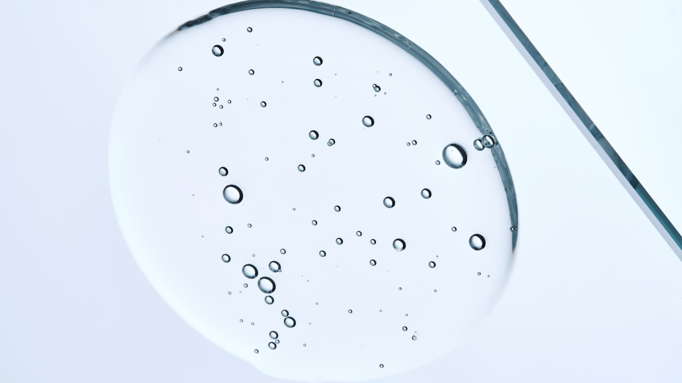 Clear glycol sample with suspended bubbles showing a synthetic liquid substance commonly used in heat transfer, cooling systems, HVAC systems, hydraulic fluids, automotive antifreeze, deicing solutions, and freeze protection applications across various industries. This odorless liquid organic compound from the alcohol family demonstrates low volatility, stable freezing point control, and efficient heat transfer properties for industrial applications.