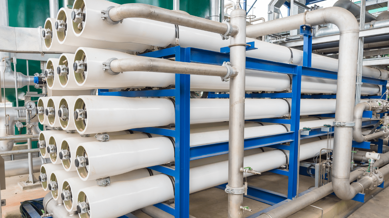 Industrial reverse osmosis system with stainless piping, high pressure pumps, pressure relief valves, pressure gauges, and stacked reverse osmosis membranes and ro membranes mounted on blue ro skids and an osmosis skid for advanced water treatment and drinking water production. The ro system supports continuous operation, controlled flow rates, temperature monitoring, and low energy consumption for optimal performance, energy efficiency, and stable water quality in modern reverse osmosis plants using advanced reverse osmosis technology and packaged reverse osmosis solutions.