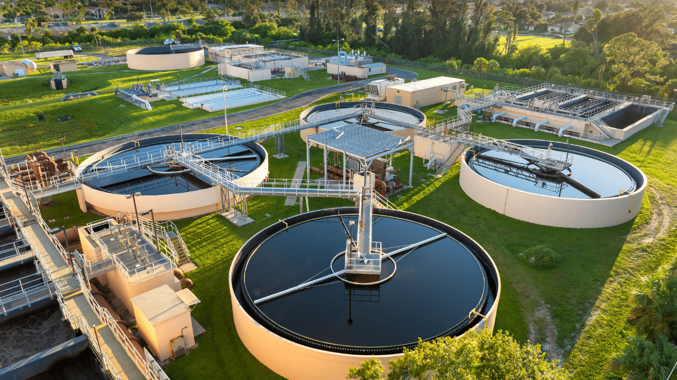 Industrial water treatment in Colombia facility featuring large clarifier tanks, filtration systems, and wastewater processing infrastructure viewed from above.