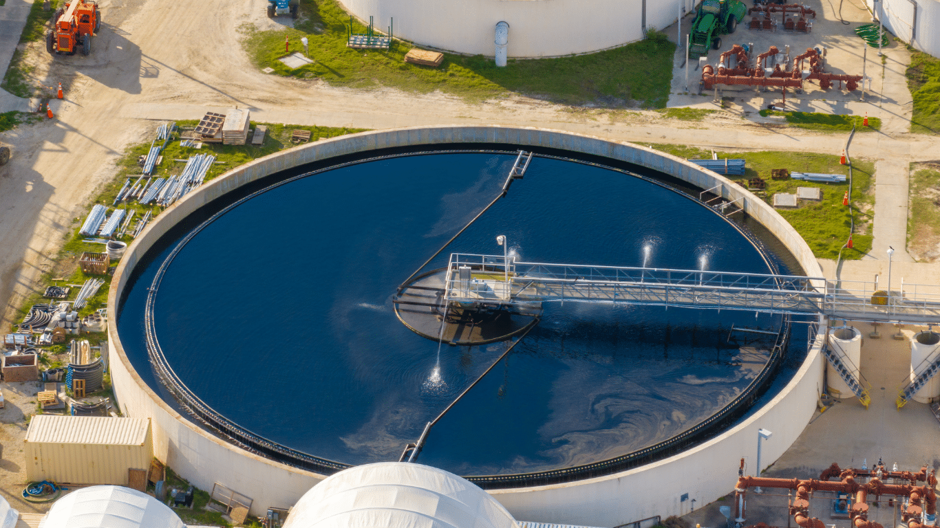 Industrial water treatment in Dayton facility with a large circular clarifier tank, surface aeration system, and wastewater processing equipment captured from an aerial perspective.