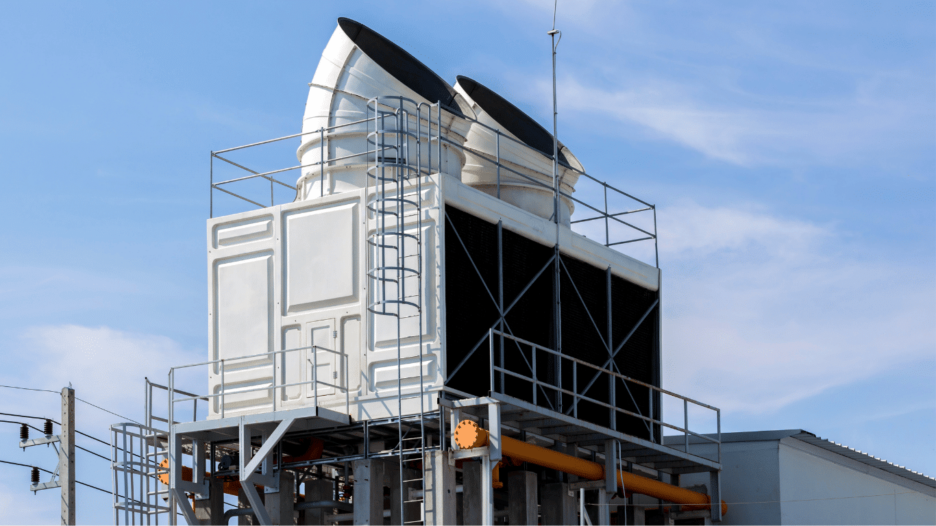 Industrial cooling tower system at a commercial facility illustrating cycles of concentration in a cooling system. The image represents tower operation where makeup water, tower blowdown, and cooling tower blowdown control dissolved solids, total dissolved solids, tower water, and system water to improve heat transfer efficiency, thermal efficiency, water efficiency, and overall system performance through effective chemical water treatment and water treatment programs.