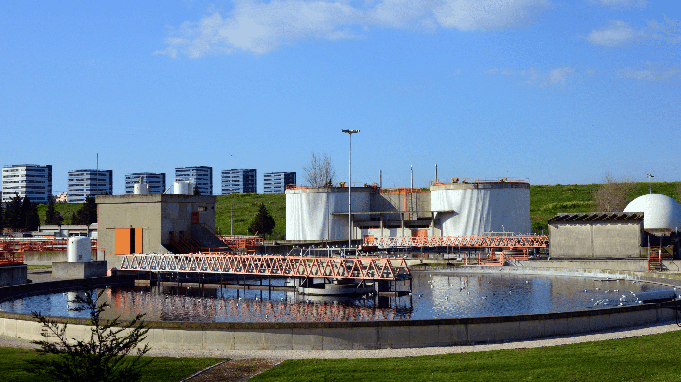 Industrial wastewater treatment facility with circular sedimentation tanks, dissolved air flotation (DAF systems), and connected equipment designed for effective solids removal across various flow rates. The integrated wastewater treatment processes handle industrial wastewater from diverse industrial processes, improving water quality and effluent quality through air flotation, sedimentation, filtration, and separation. The mixing system supports polymer addition and chemicals dosing, while compressed air enables dissolved air flotation DAF to capture fine particles, flocculated solids, suspended solids, solid particles, and larger particles for reliable removal. The process enhances operational efficiency, delivers cleaner effluent, supports high performance and reliable performance, and reduces clogging under different flow rates. Collected sludge is transferred to a dewatering unit with belt presses, producing a cake like product suitable for soil amendments or disposal, helping lower disposal costs while providing cost savings. The method considers particle size, density, surface properties, composition, concentration, temperature, organic matter, and other characteristics that influence settling, flotation, and overall treatment performance.