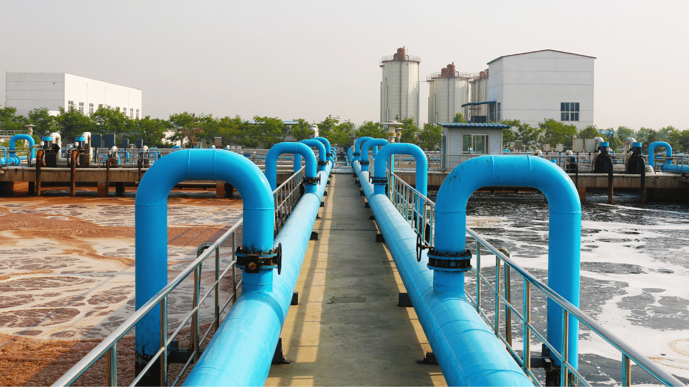 Aerated wastewater treatment system with blue pipes, aeration tanks, oxygen-rich water, and treatment processes at an industrial treatment plant.