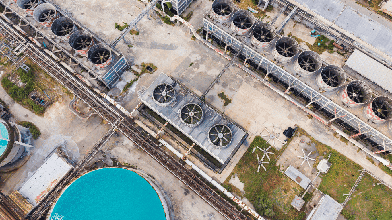 Industrial cooling water system with cooling towers, tower fill, circulating coolant, process equipment, industrial pipes, and water systems supporting heat transfer and heat rejection at an industrial facility.