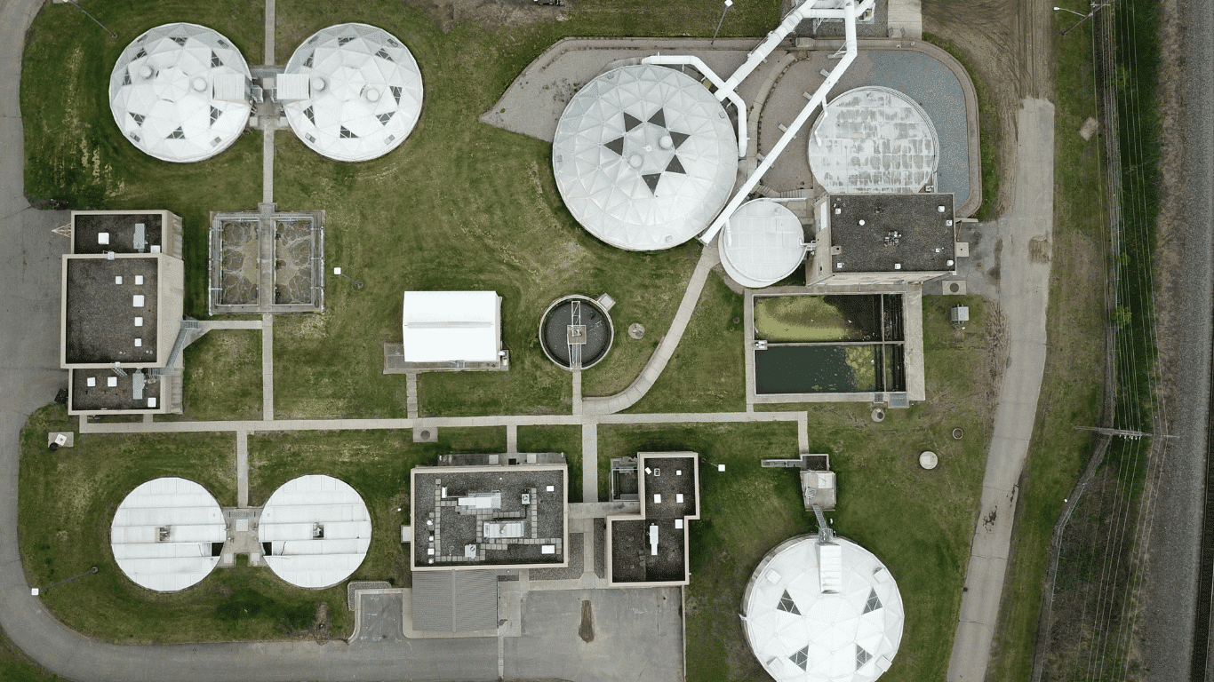 Aerial view of a wastewater treatment plant showing treatment tanks, flow systems, and wastewater treatment equipment used for grit removal and solids handling.