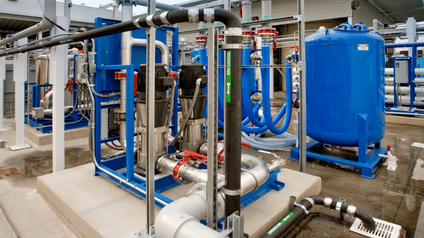 Industrial membrane filtration system with blue treatment vessels, pumps, pipes, and filtration equipment used in water treatment and industrial applications.