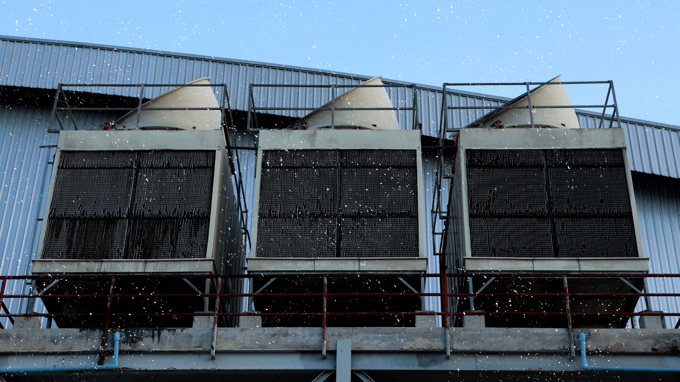 Cooling tower equipment in winter weather with snow, illustrating freeze protection, heat, water, pipes, pumps, and seasonal shutdown.