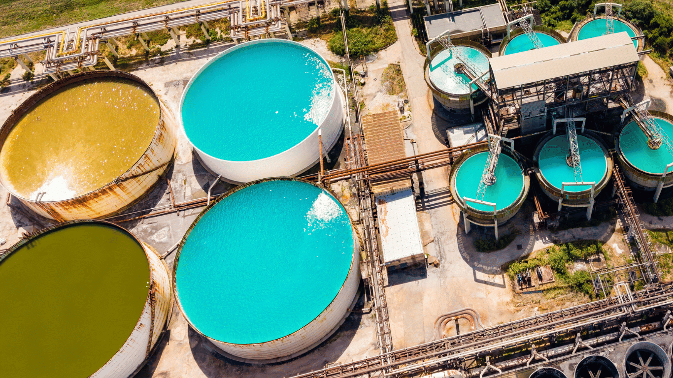 Industrial wastewater treatment facility with large treatment tanks, filtration systems, and process equipment for water treatment and clean water production.