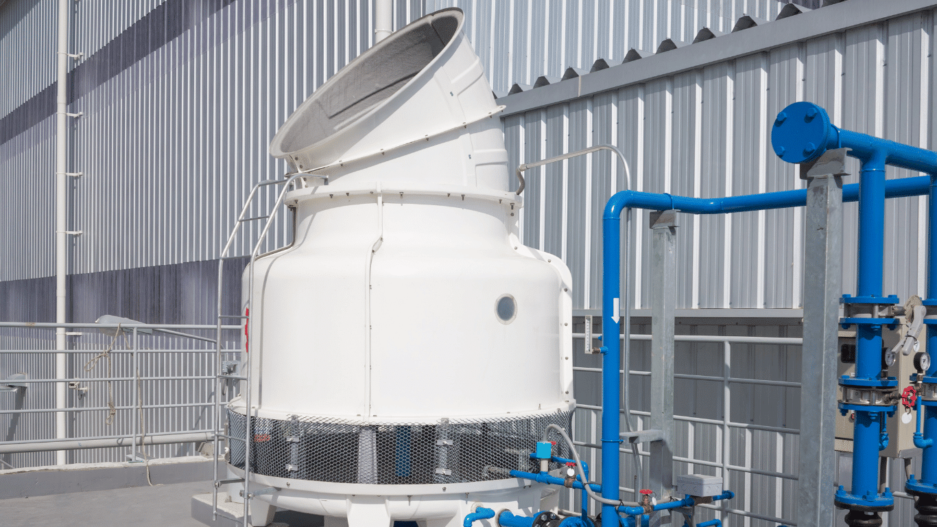 Industrial cooling tower with blue cooling water piping, tower components, and treatment system used to support heat transfer efficiency and equipment longevity.