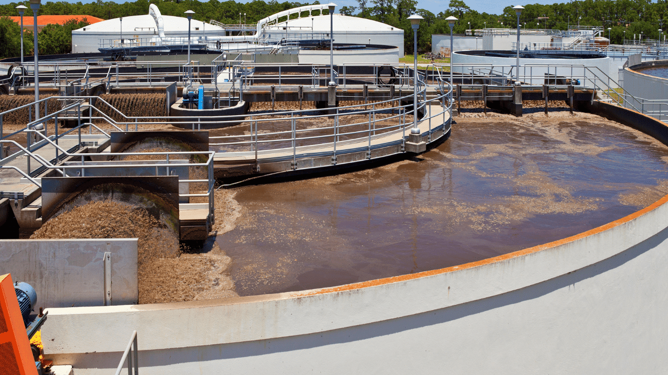 Circular wastewater treatment basins and mechanical equipment at a treatment facility, illustrating biological treatment and landfill leachate treatment systems for waste management and environmental protection.