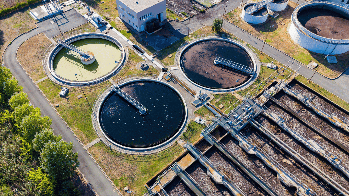 Aerial view of wastewater treatment plants and water treatment facilities showing treatment processes, filtration, monitoring, sensors, and systems used to maintain water quality and support safe water management.